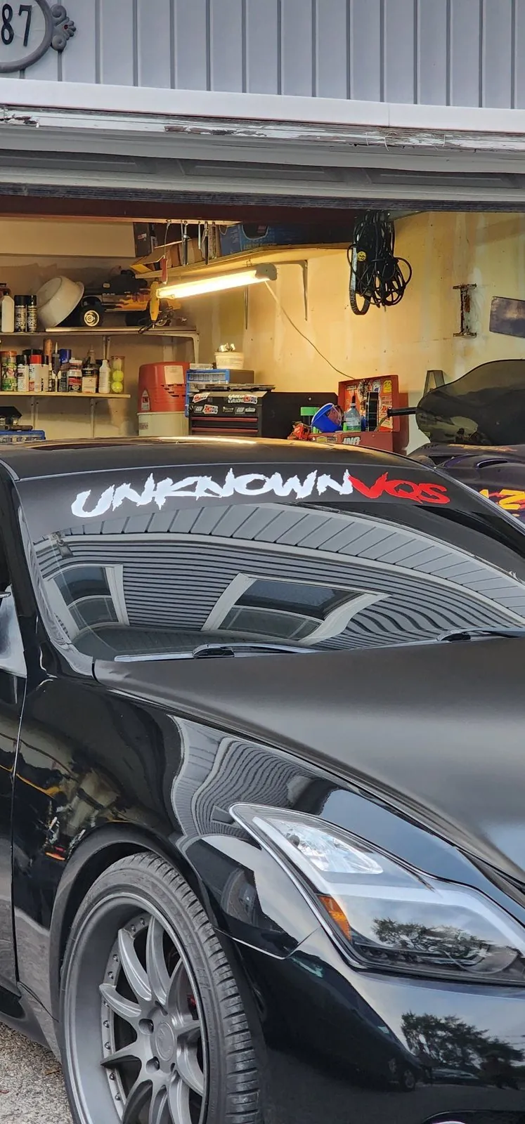 Windshield banner being fitted in a garage